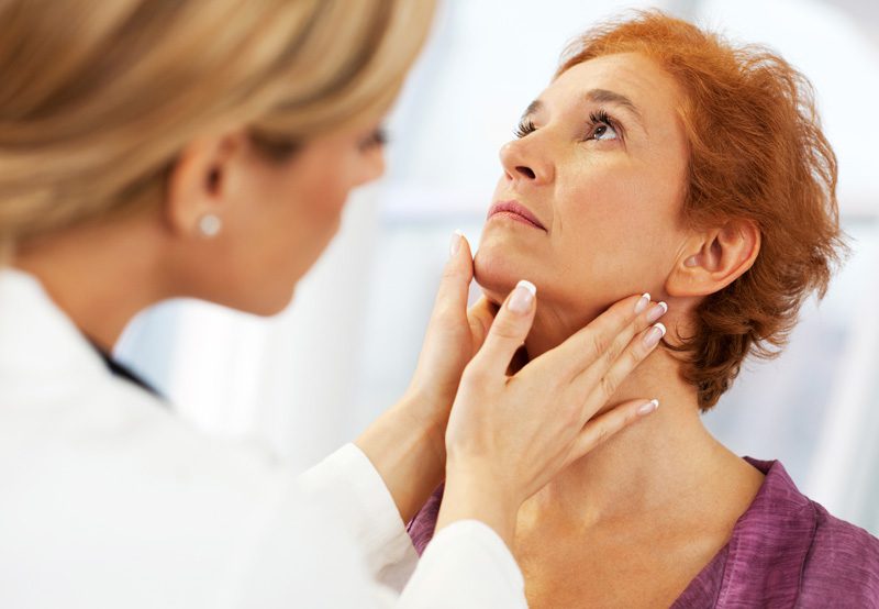 Doctor-examining-female-patient-before-conducting-laryngoscopy