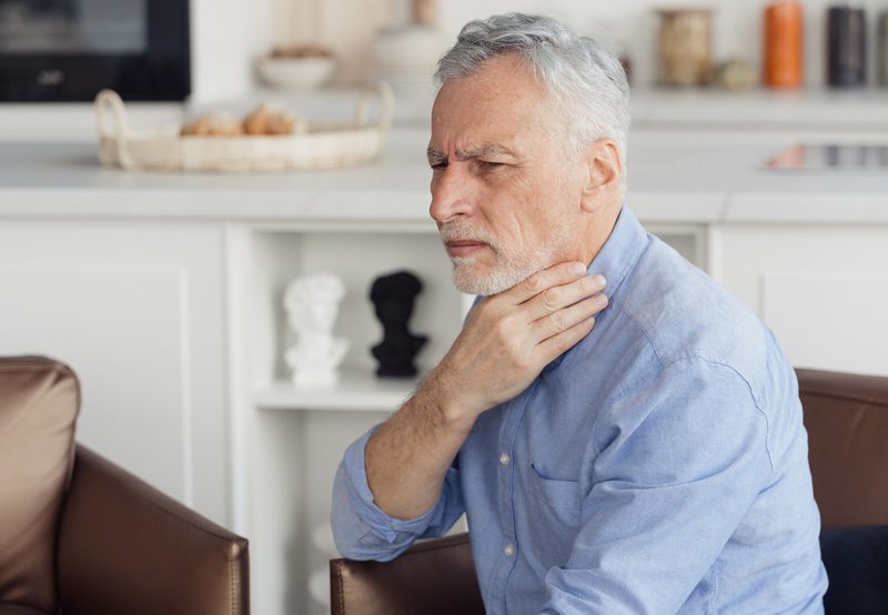 Elderly-man-experiencing-symptoms-of-voice-disorder